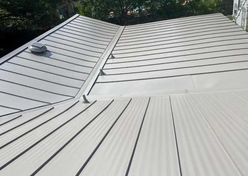 Solar attic fan installed on a metal roof for Roof Ventilation in Roseburg